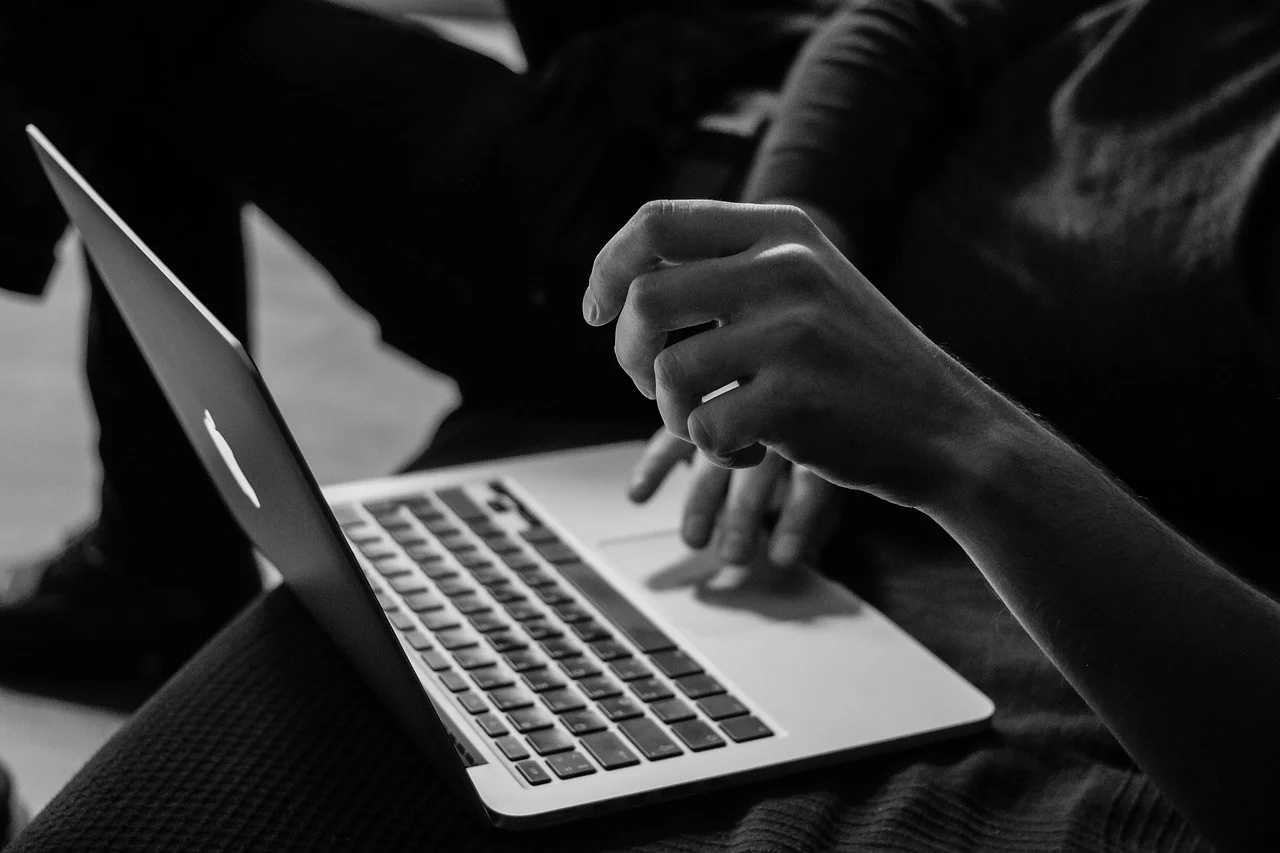 Person using a laptop computer in a dark setting